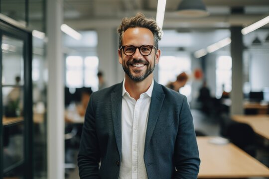 Portrait of a smiling young caucasian man working in a startup company office