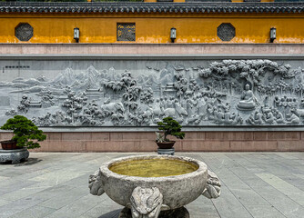 Buddhist relief at entrance to historic Zhiyuan Temple at Mount Jiuhua (jiuhuashan), dedicated to Ksitigarbha Bodhisattva and one of Four Sacred Buddhist Mountains in China, Qingyang, Chizhou, Anhui.