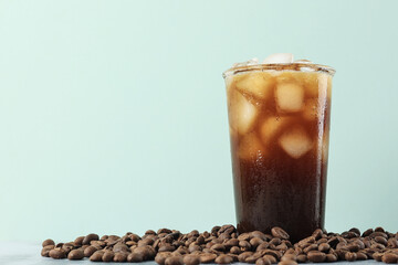 Iced Americano Coffee with Coffee Beans on Light Background