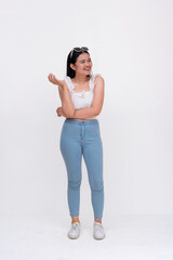 A pretty young extroverted asian woman looking carefree. Full body photo isolated on a white backdrop.