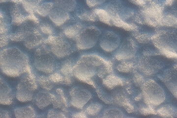 Melting snow cover during a thaw close up