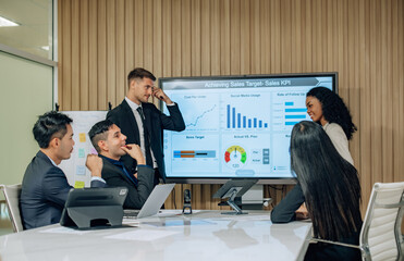 Diverse team innovates for sales KPIs via collaborative brainstorming to develop business models.