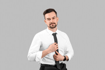 Handsome businessman on grey background