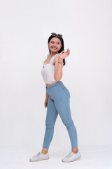 A young asian woman saying hi while walking. Side view whole body photo isolated on a white...