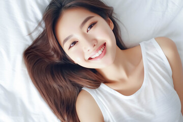 Obraz na płótnie Canvas Pretty Asian young lady lies on indoor bed. She keeps eyes open and looks satisfied with positive thinking and smiling to camera. Generative AI.