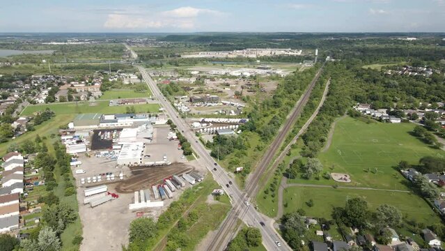 Panoramic aerial pullback above giant large x intersection with long sprawling road way