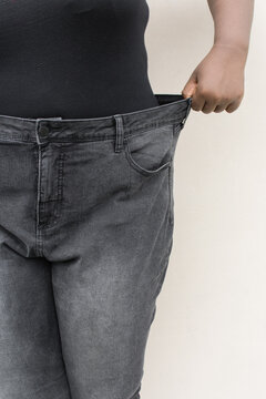 Woman Showing Off Weight Loss In Loose Jeans, Poor Fitting Jeans At The Waist, Plussize Woman In Big Denim Trousers