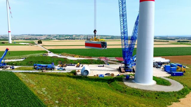 Crawler Crane Lifting Nacelle At Wind Turbine Installation Site. drone ascend
