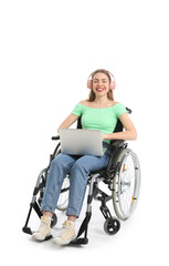 Fototapeta na wymiar Young woman in wheelchair with headphones and laptop on white background
