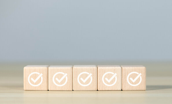 Wooden blocks display markers to summarize the details of the work. Document checklist and online quality assessment standards