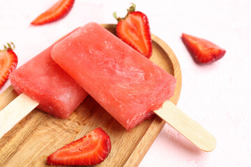 Wooden board with strawberry ice creams and fresh berries on pink grunge background