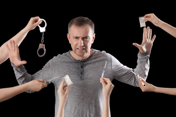 Mature junkie rejecting drugs on black background