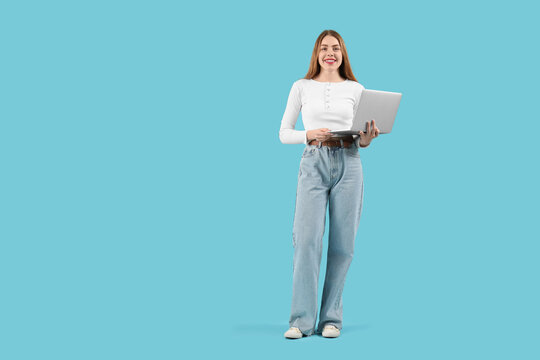 Female programmer with laptop on blue background