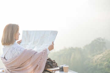 Girl tourist in mountain read the map and looking mountain view at countryside homestay in the...