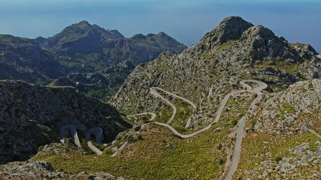 Serpentine Asphalt Roads Of Nus De Sa Corbata At Coll dels Reis Rocky Mountains In Mallorca, Spain. Aerial Drone Shot