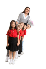 Obraz premium Little school children with female teacher on white background