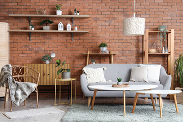 Interior of living room with armchair, sofa and houseplants