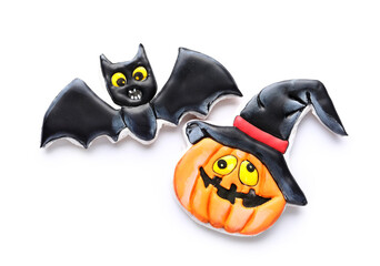 Tasty cookies in shape of pumpkin and bat for Halloween celebration on white background