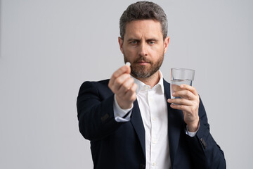 headache painkiller. tired business man take painkiller. man ceo offering painkiller for a headache. stressed and tired businessman. business overwork. chronic fatigue. businessman taking pill