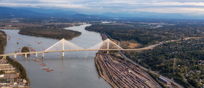 Aerial View of Fraser River and City. Cloudy Sunset Sky. Panorama. Pitt Meadows, Vancouver, BC, Canada