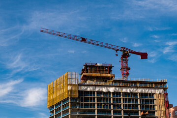 construction od building. industrial crane at construction site. architecture. constructing skyscraper. construction crane. architectural background - obrazy, fototapety, plakaty
