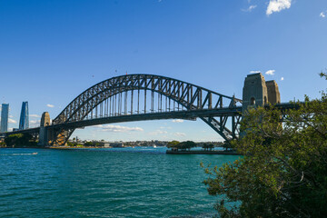 Fototapeta na wymiar A view from a tree line of the Sydney Harbour Bridge on a sunny winter day