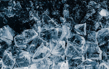 Pieces of crushed ice cubes on black background.