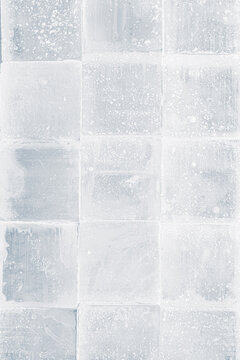 Textured frosty crystal square translucent ice blocks pattern background.