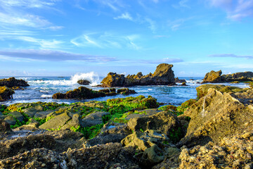 Sawarna Beach Beautiful skies and large rocks adorn the shore.