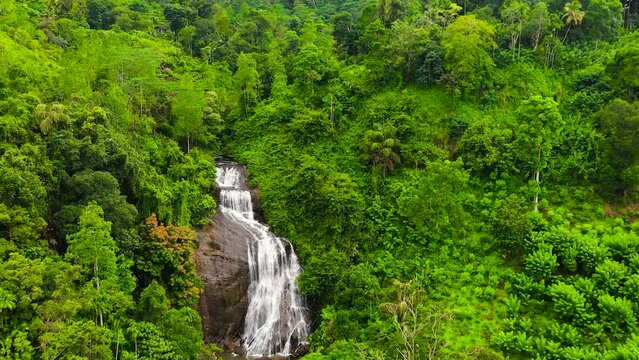 Waterfalls among the green forest view from above. Kuda Falls, Sri Lanka.