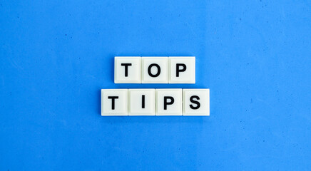 letters of the alphabet with the word top tips. the concept of finding or getting tips