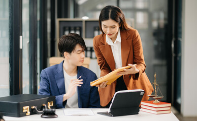 Asian business team and lawyers discussing contract papers sitting at the table. Concepts of law, advice, legal services. at office