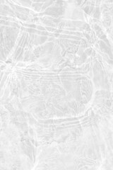 White water with ripples on the surface. Defocus blurred transparent white colored clear calm water surface texture with splashes and bubbles. Water waves with shining pattern texture background.