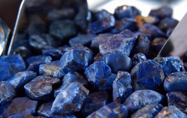 Lapis Is a beautiful natural gemstone on a wooden floor.