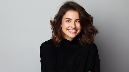 Obraz premium Smiling woman with her arms crossed on gray studio background, excited and headshot of young female person 