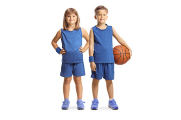 GIrl and boy in sport jerseys posing with a basketball