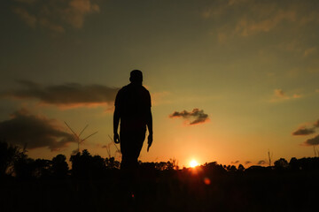 Concept of wanderlust a man standing at sunset