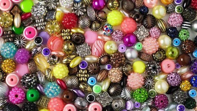 Charms, beads for self-manufacture of bracelets, Necklace or beads and other jewelry. 4K Video, Rotating.