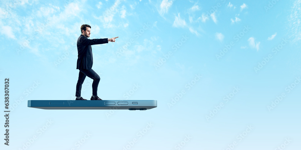 Aufkleber User experiences for mobile concepts. Young businessman pointing forward on huge flying smartphone on wide bright blue sky background with mock up place.