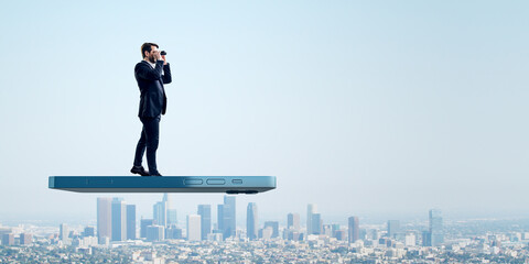 User experiences for mobile concepts. Young man with telescope standing on huge flying smartphone...