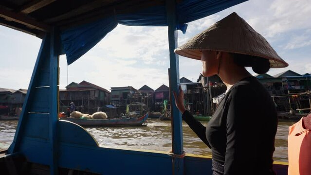 A Lady Enjoying A Trip On A Floating Village