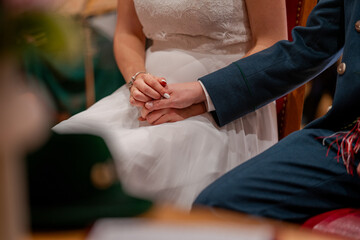 Married couple hold their hands during the wedding ceremony