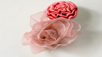  pink rose-shaped brooch made of cloth - obrazy, fototapety, plakaty