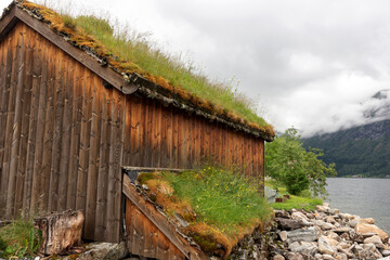 Old wooden house with grass on the roof. Norway