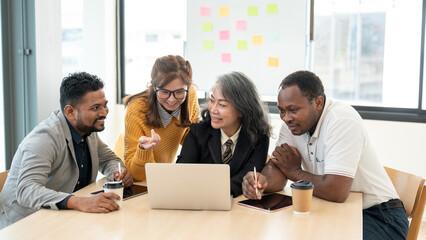 Fototapeta premium A group of happy, diverse businesspeople or startups is enjoying discussing work