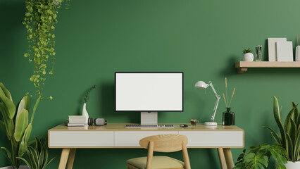 Modern green home office workspace with a computer on a desk, indoor tropical plants, a chair