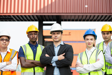 Group of team logistic worker and manager standing in arms crossed at container warehouse....