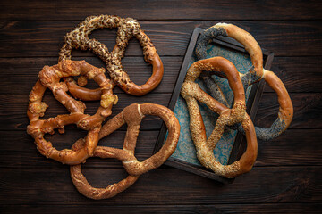 Different types of pretzels, a picture for decorating bakery sales points on brown boards. For decoration of bakery sales outlets. Bakery products. Fresh bakery.