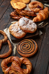 Wallpaper from different types of pastries on brown boards. For decoration of bakery sales outlets....