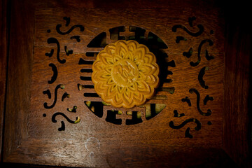 Round shaped Chinese traditional mooncakes on wooden background. Mid Autumn festival and Chinese traditional festival.